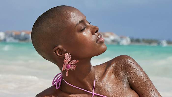 Madisin Rian was photographed by James Macari in the Dominican Republic. Earrings by Lele Sadoughi.